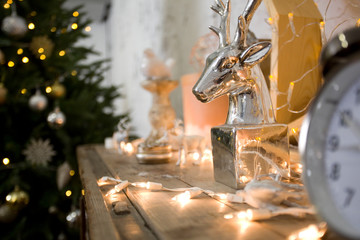 vintage table clock. Vintage interior decor. Gold watches, flashlights, home decoration. Christmas interior. Deer head, candles, porcelain decor.