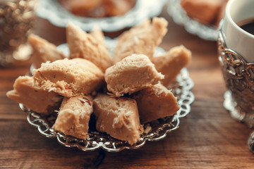 Turkish sweets with coffee on a wooden table