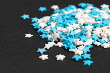 Colored star shaped candy sugar sprinkles as a background