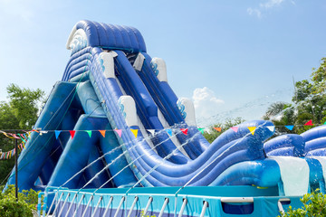 inflatable slide bounce or water sliders at water park - obrazy, fototapety, plakaty