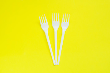 Disposable plastic plugs on bright yellow background with copy space.