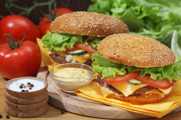 Two fresh hamburgers with vegetables