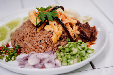 Thai shrimp paste fried rice with shallot, sweet barbeque pork, egg and vegetable