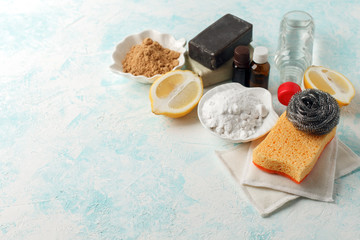 Zero waste, compostable domestic cleaning tools. Metal dish brush, cellulose sponge, rags, soap, lemon, vinegar, essential oils . Eco friendly concept
