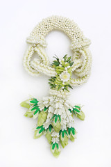 Traditional thai style fresh flower garland on white background. Top view.