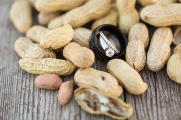 Close up of wedding rings in pile of peanuts