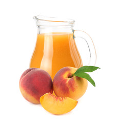 jug of peach juice with peach fruit and slices isolated on white background.