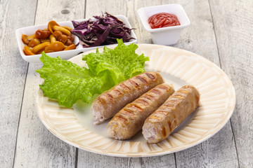Grilled sausages served mushrooms and cabbage