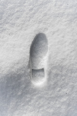 footprint of a man in a boot in the snow