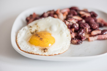 English tastefull breakfast with fried bacon, beans and eggs
