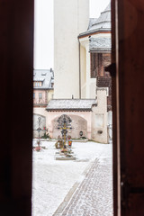 Fototapeta premium Winter. Exterior of the ancient Collegiate Church of San Candido. Snow atmosphere