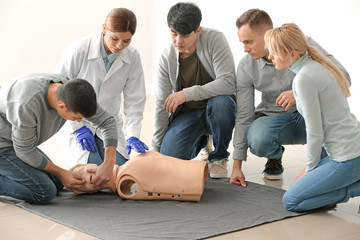 People learning to provide first aid at training course
