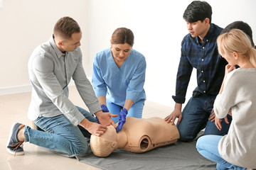 People learning to perform CPR at first aid training course
