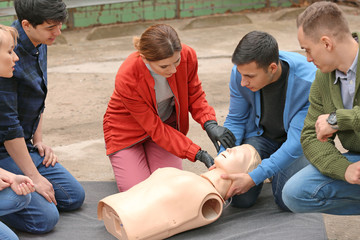 People learning to perform CPR at first aid training course