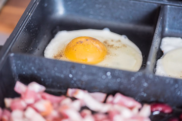 English tastefull breakfast with fried bacon, beans and eggs