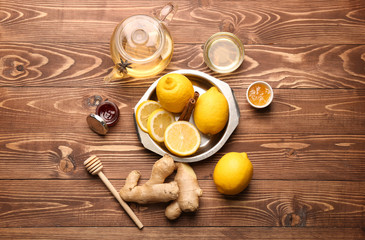 Tasty tea with lemon, ginger and honey on wooden table