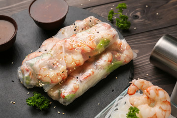 Tasty spring rolls on slate plate