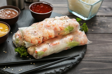 Tasty spring rolls on slate plate
