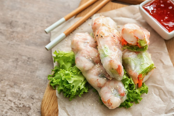 Tasty spring rolls on board
