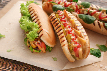 Tasty hot dogs on table