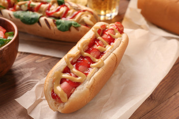 Tasty hot dog on wooden table