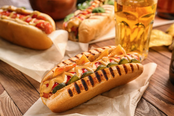 Tasty hot dog on wooden table
