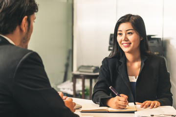 Businesswoman from human resources department is interviewing businessman candidate for job...