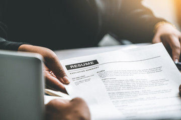 Close up view of employee candidate hands CV resume document to the interviewer HR human resources...