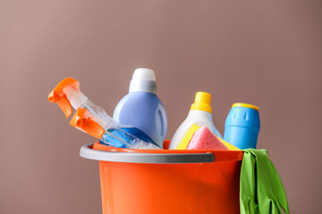 Set of cleaning supplies on color background