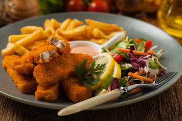 Fish sticks with fries and salad.
