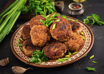 Juicy delicious meat cutlets on a dark table. Russian cuisine.