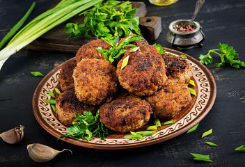 Juicy delicious meat cutlets on a dark table. Russian cuisine.