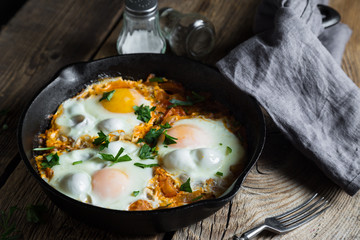 Shakshuka, scrambled eggs in roasted tomato sauce