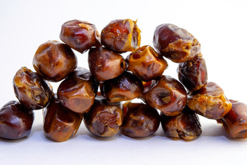 Four rows of sweet dry dates, isolated on white background.