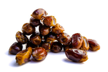 Obraz premium sweet dry dates folded down and laid out on a white background