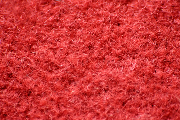 The texture of the felt is red. The fleecy surface is dark red. Close up. Can be background.