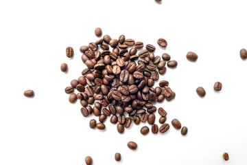 Roasted coffee beans isolated on white background. Close-up.