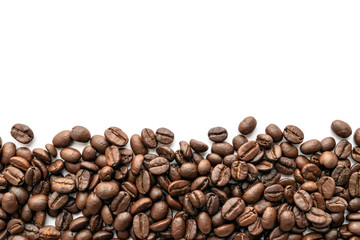 Roasted coffee beans isolated on white background. Close-up.