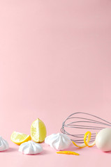 Vertical shot.Cooking utensil, egg, lime and fresh meringues on the pink surface.Empty space for your design. Concept for cooking book cover