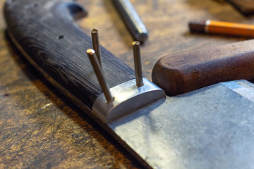 Making brown wooden knife handle rivet with pins process close up