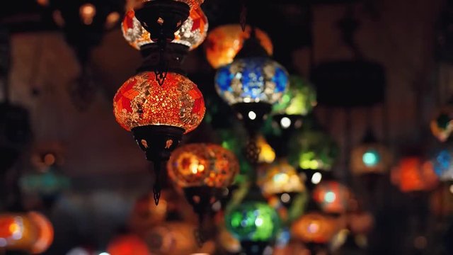 Slowmotion. Camera moving throught traditional turkish lamps at night time