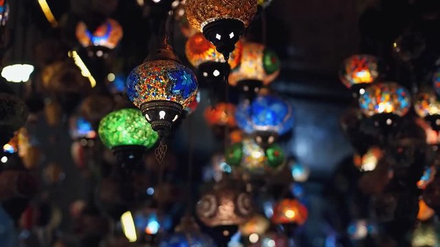 Slowmotion. Camera moving throught traditional turkish lamps at night time