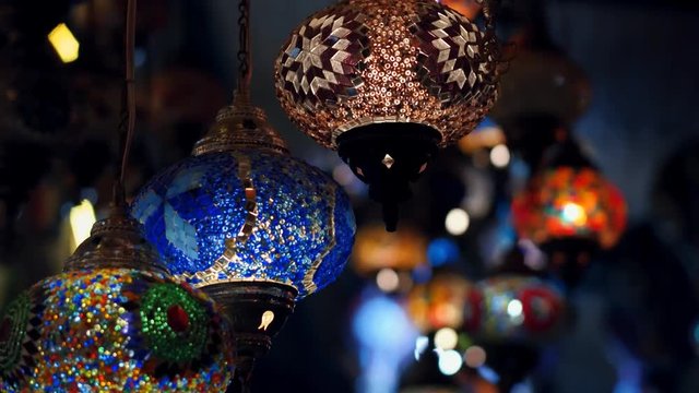 Camera moving throught traditional turkish lamps at night time