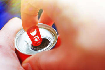 the man opened an aluminum can of beer