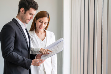 Businessman executive is in meeting discussion with businesswoman or client in modern workplace...