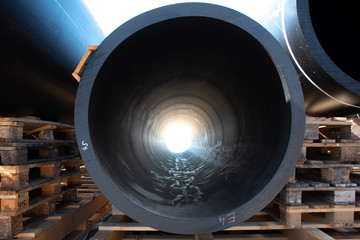 Bright light seen through large black HDPE plastic pipe