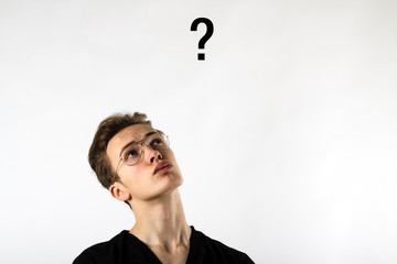 Young man is full of doubts and hesitation. Young man and Question mark.
