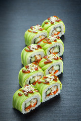 Japanese green sushi, rolls on a dark background