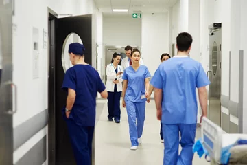 Fotobehang Doctors walking through corridor in hospital © gpointstudio