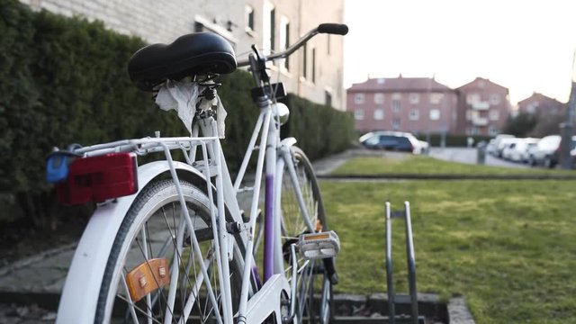 Closeup of an old bicycle with papers under the sadel blowing in the wind